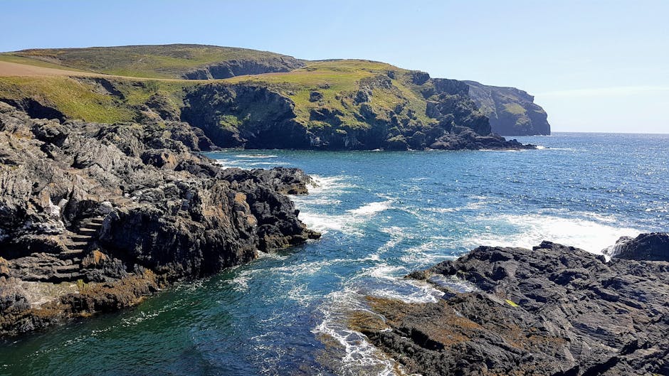 Captivating view of the rugged coastline and blue sea at the Isle of Man.